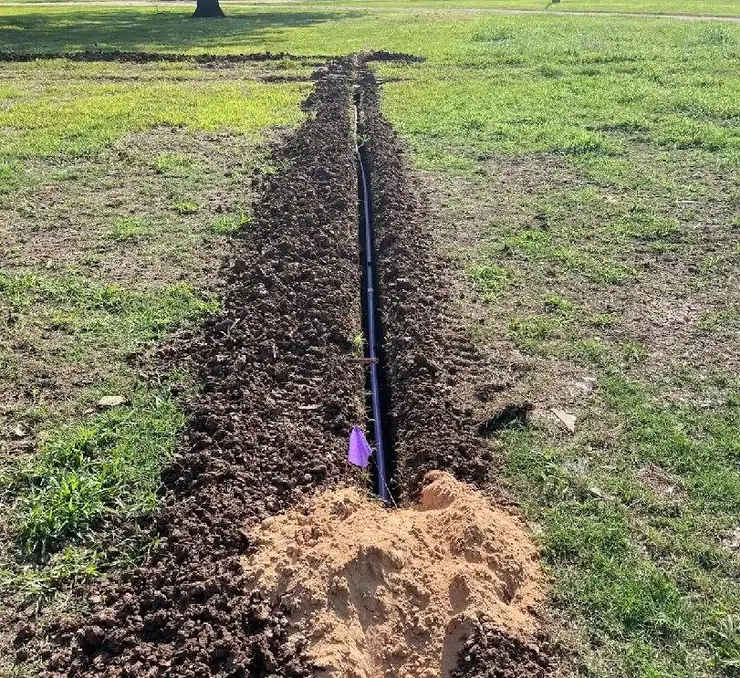 Excavated trench with conduit pipe for a septic line